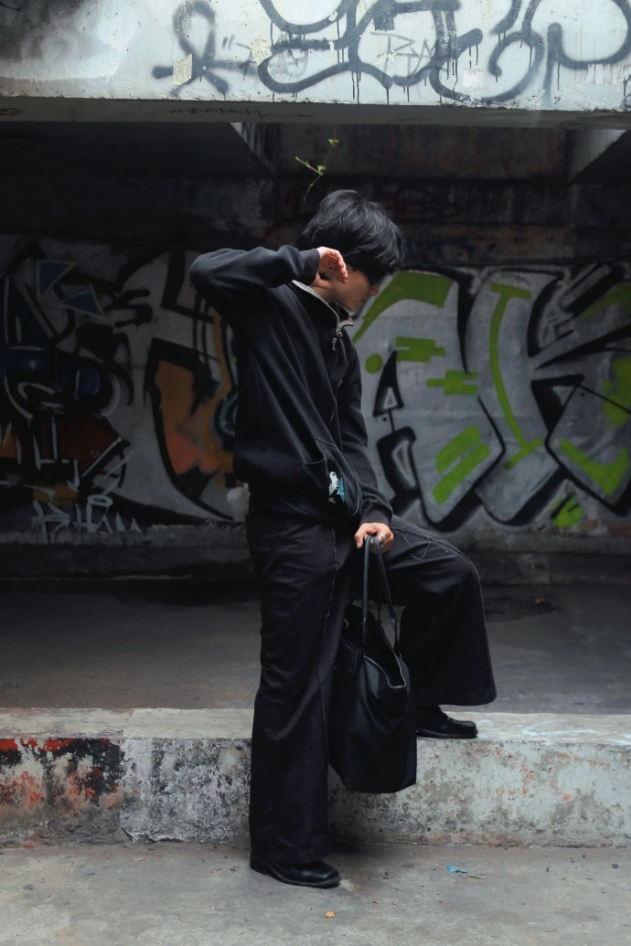 a man in a black suit is standing on some steps